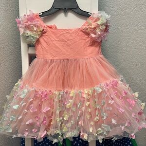 Lola the boys size 6 butterfly dress would fit a 5 better. It’s short puff dress